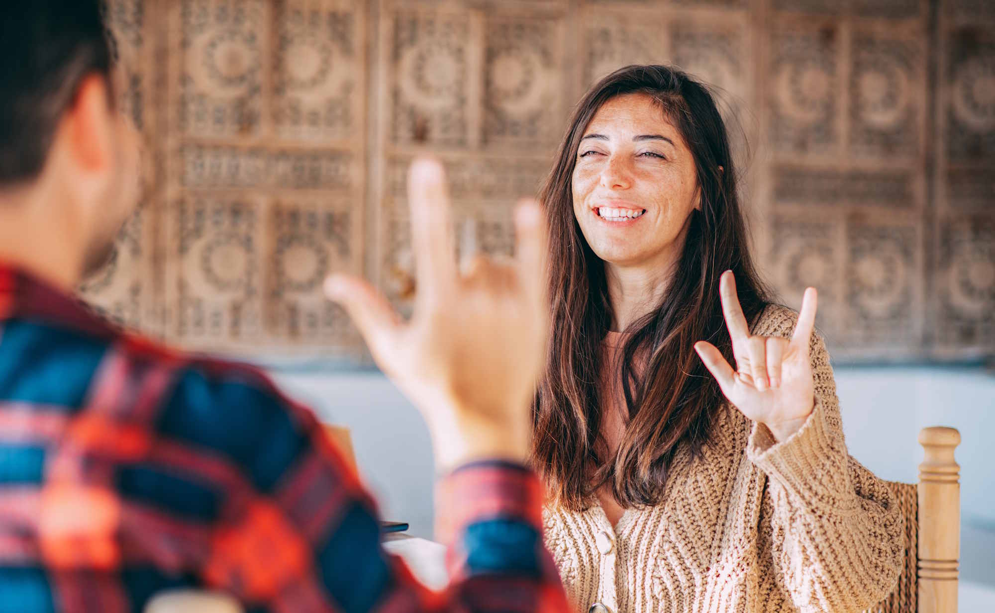 A young couple communicating in sign language